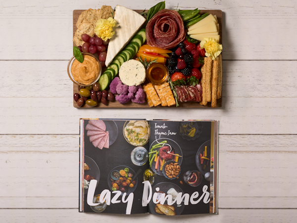 Book open to 'Lazy Dinners' with charcuterie board