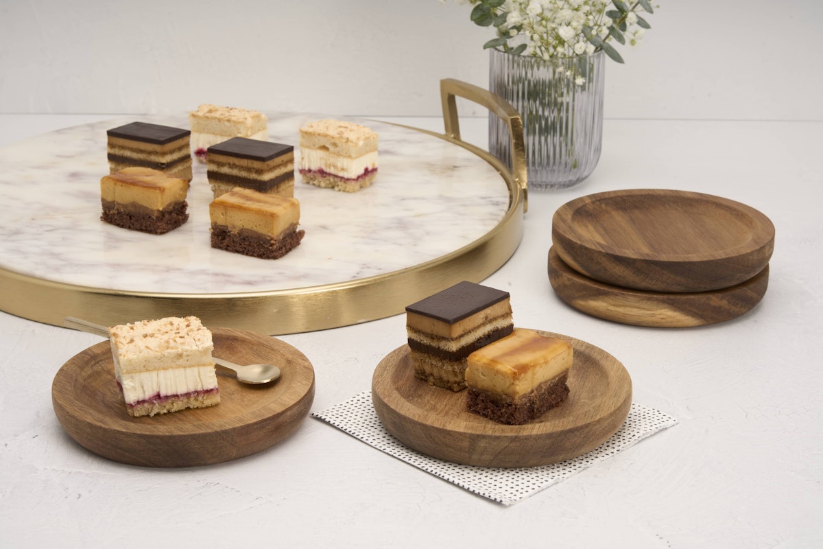 Acacia plates with tiny layered cake desserts on display