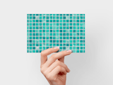 Hand holding card with blue tiles